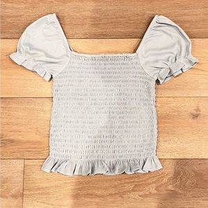 Light sky-blue crop top with very particular drape details